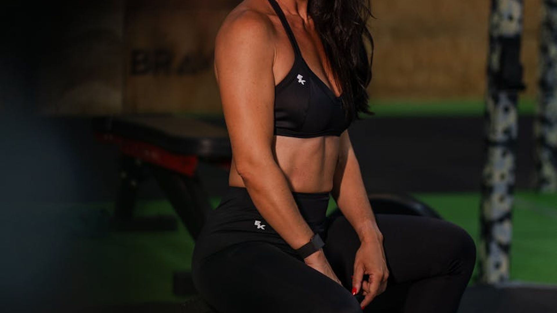 Athletic person doing cardio exercises in a dark premium gym environment