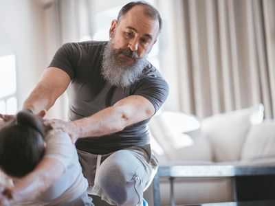 Person hands doing stretching exercises in dark lighting